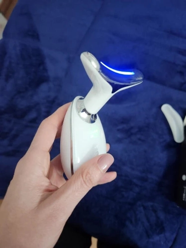 Customer photo of the facial beauty device held with blue light on